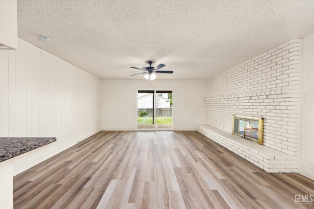 2904 Brock Way, Bakersfield, CA 93306 - unfurnished living room featuring light wood finished floors, a textured ceiling, ceiling fan, and a fireplace