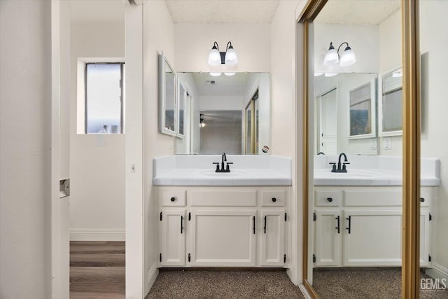 2904 Brock Way, Bakersfield, CA 93306 - bathroom with two vanities, a sink, visible vents, and baseboards