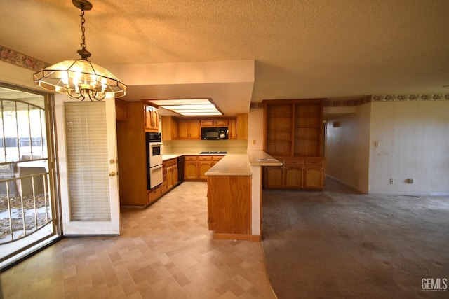 kitchen with plenty of natural light, white appliances, hanging light fixtures, a notable chandelier, and kitchen peninsula