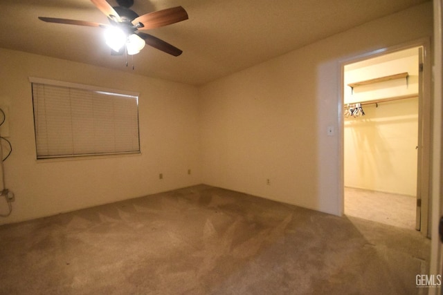 unfurnished bedroom with ceiling fan, a closet, and light colored carpet