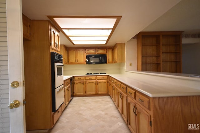 kitchen featuring kitchen peninsula and black appliances