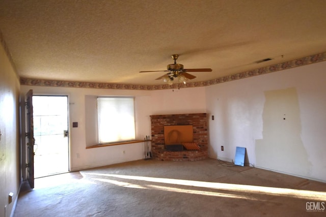 unfurnished living room featuring carpet, a textured ceiling, and ceiling fan