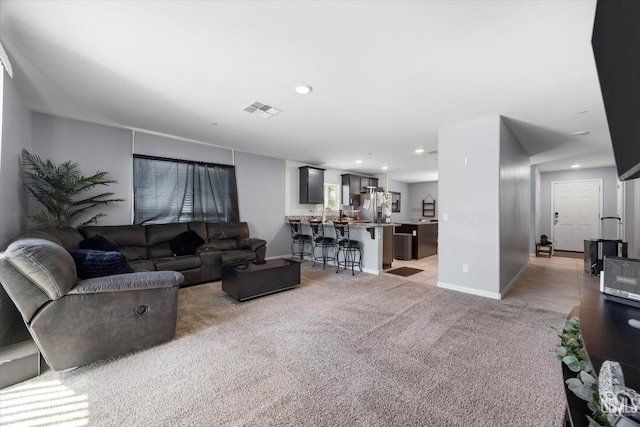 living room with light colored carpet, baseboards, and recessed lighting
