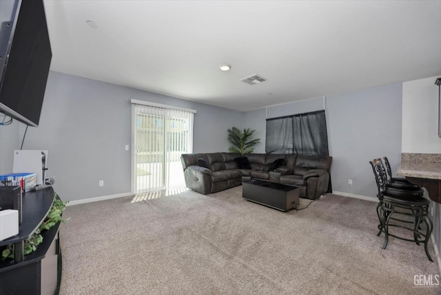 living area with baseboards and carpet floors