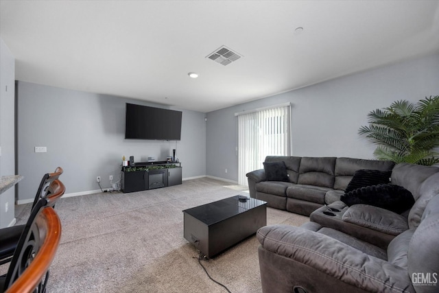 living area with light colored carpet and baseboards