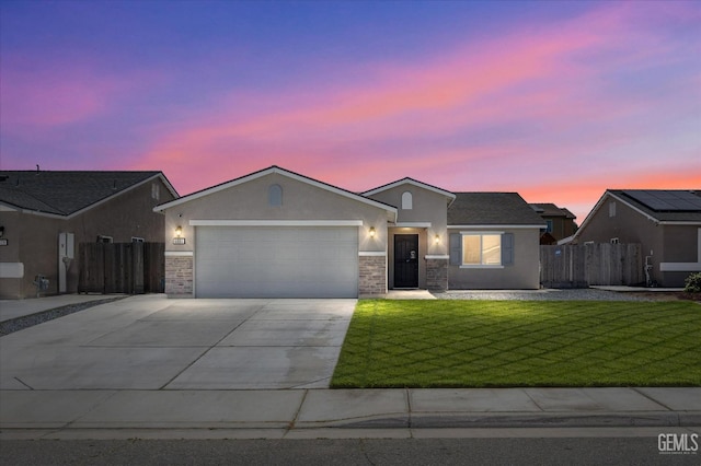ranch-style home with stucco siding, an attached garage, concrete driveway, and brick siding