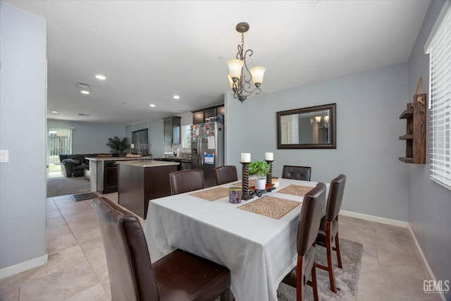 dining area with light tile patterned floors, a chandelier, baseboards, and recessed lighting