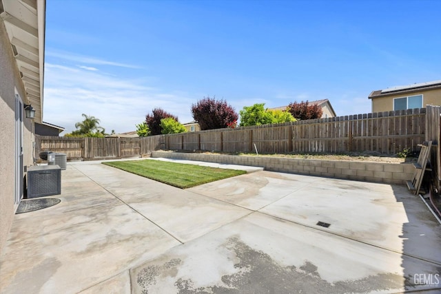 view of patio with a fenced backyard and central AC unit