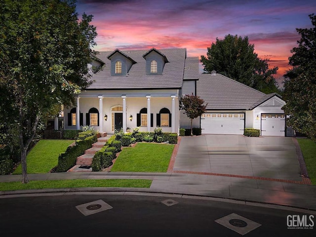 view of front facade featuring a yard and a garage