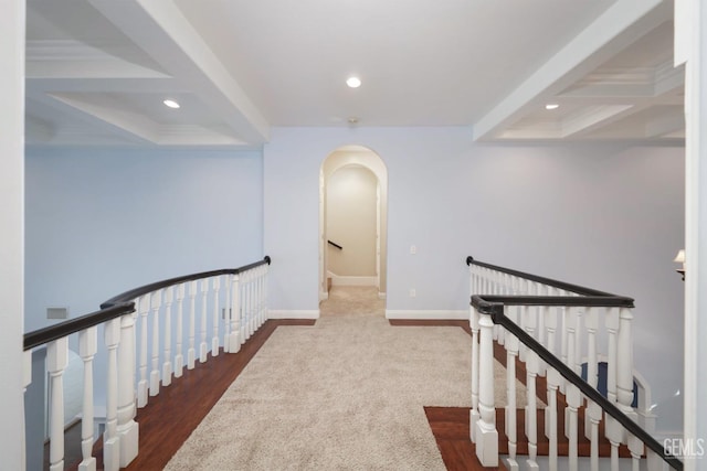 hall featuring beamed ceiling, wood-type flooring, and coffered ceiling