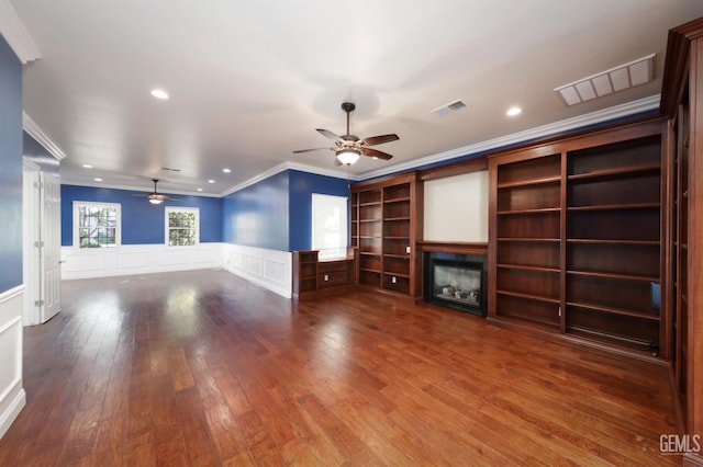 unfurnished living room featuring hardwood / wood-style floors, ceiling fan, and crown molding