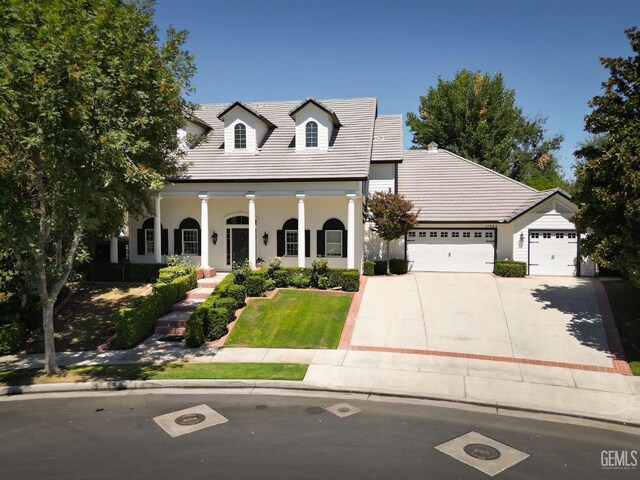 view of front facade featuring a porch and a garage