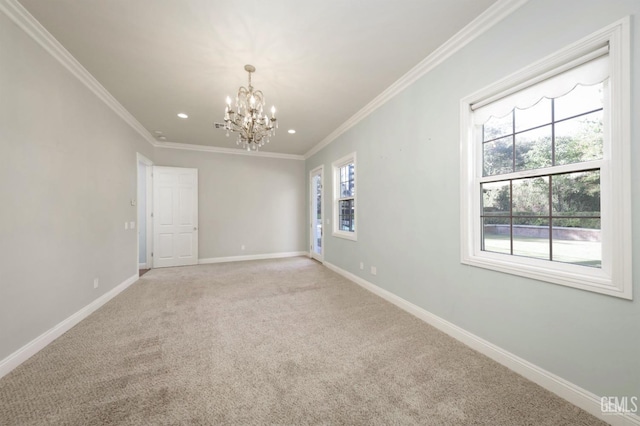 carpeted empty room featuring ornamental molding and an inviting chandelier