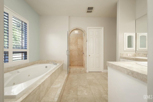 bathroom with tile patterned floors, vanity, and plus walk in shower