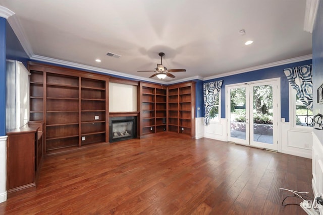 unfurnished living room featuring french doors, crown molding, ceiling fan, and dark wood-type flooring