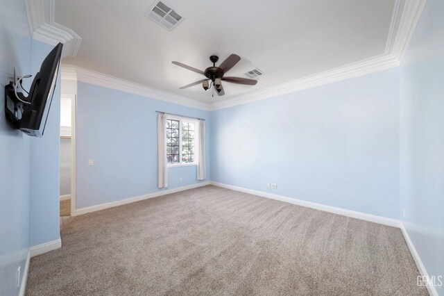 empty room with crown molding, carpet floors, and ceiling fan