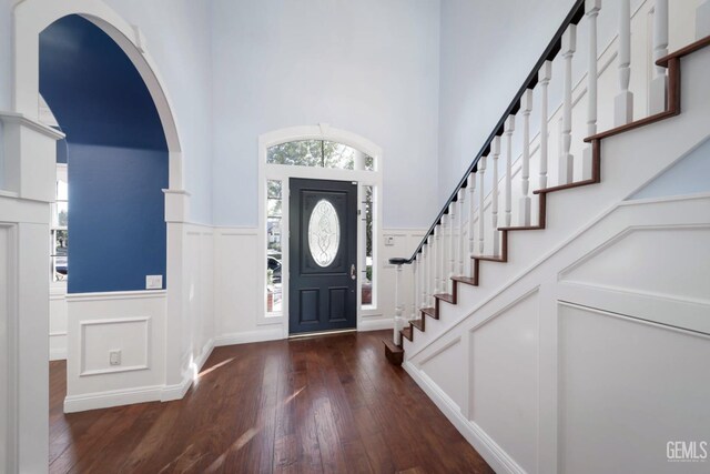 entrance foyer featuring a high ceiling and dark hardwood / wood-style floors