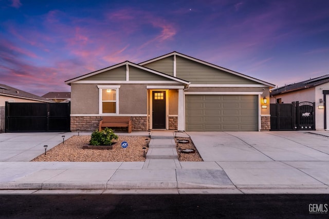6109 Pareto Pl, Bakersfield, CA 93313 - single story home with stone siding, a gate, concrete driveway, and an attached garage
