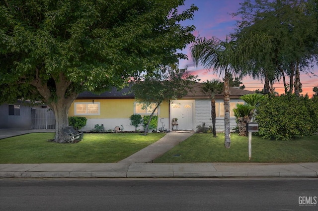 4501 Chadbourn St, Bakersfield, CA 93307 - ranch-style home with a lawn and stucco siding