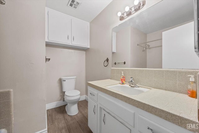 4501 Chadbourn St, Bakersfield, CA 93307 - full bathroom with decorative backsplash, vanity, wood finished floors, and a shower