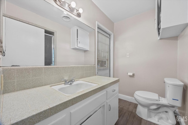 4501 Chadbourn St, Bakersfield, CA 93307 - full bathroom featuring vanity, wood finished floors, decorative backsplash, and a shower with door