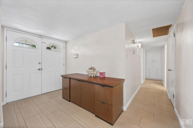 4501 Chadbourn St, Bakersfield, CA 93307 - entrance foyer featuring a textured ceiling and baseboards