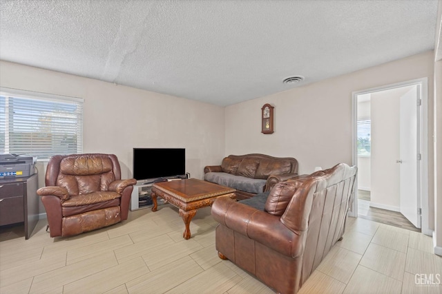 4501 Chadbourn St, Bakersfield, CA 93307 - living room with healthy amount of natural light and a textured ceiling