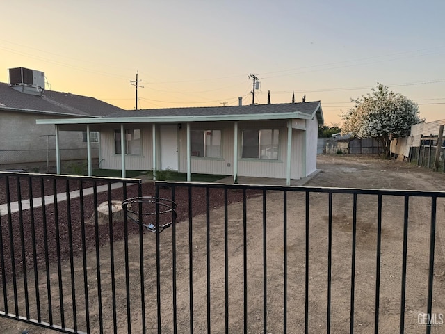 7704 Buena Vista Blvd, Lamont, CA 93241 - view of front of property with covered porch, cooling unit, and a shingled roof