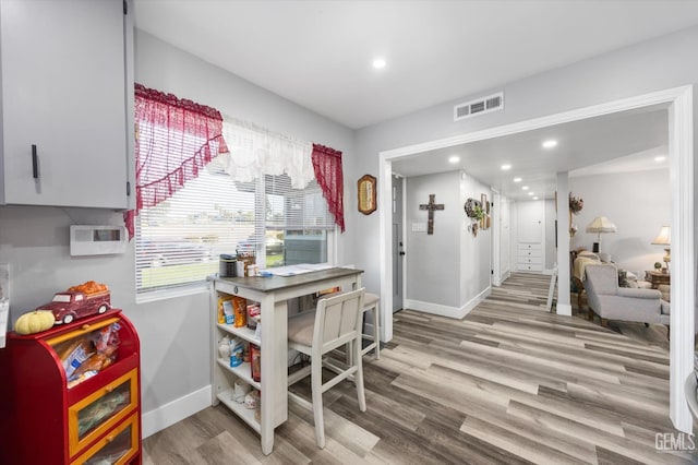 interior space with white cabinetry and light hardwood / wood-style flooring