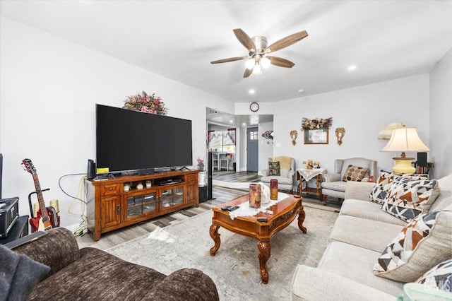 living room with light hardwood / wood-style floors and ceiling fan