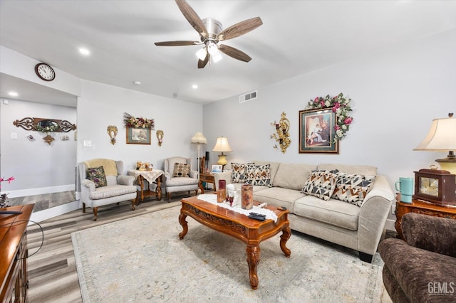 living room featuring ceiling fan and light hardwood / wood-style floors