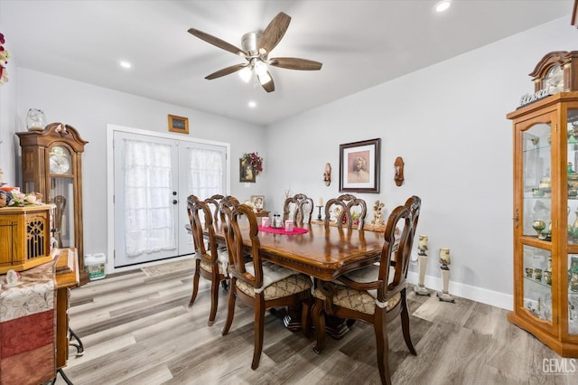 dining room with ceiling fan, light wood-type flooring, and french doors