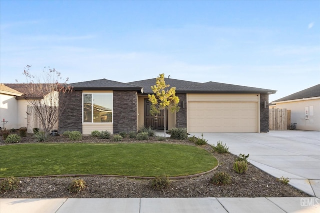 view of front of property featuring a front lawn and a garage