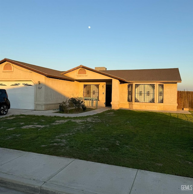 ranch-style house featuring a garage and a front yard