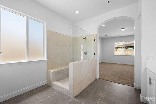 8708 Tamburlane Ct, Bakersfield, CA 93314 - full bathroom with walk in shower, tile patterned floors, recessed lighting, and vanity