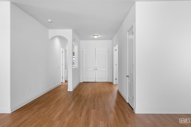 8708 Tamburlane Ct, Bakersfield, CA 93314 - corridor with arched walkways and light wood-style flooring