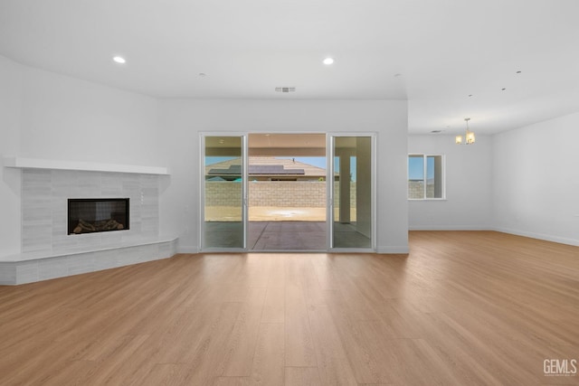 8708 Tamburlane Ct, Bakersfield, CA 93314 - unfurnished living room with a tile fireplace, wood finished floors, a chandelier, and recessed lighting
