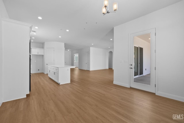 8708 Tamburlane Ct, Bakersfield, CA 93314 - unfurnished living room featuring recessed lighting, a chandelier, arched walkways, and light wood-style flooring
