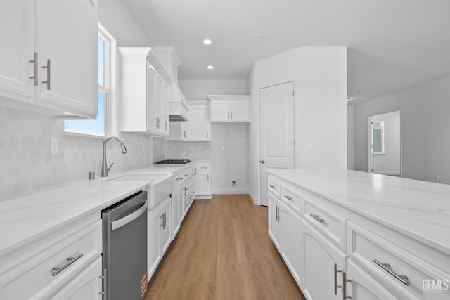 8708 Tamburlane Ct, Bakersfield, CA 93314 - kitchen featuring appliances with stainless steel finishes, light stone counters, white cabinets, light wood-type flooring, and backsplash