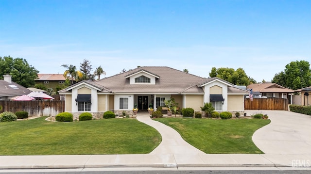 view of front of home featuring stone siding, concrete driveway, and a tiled roof