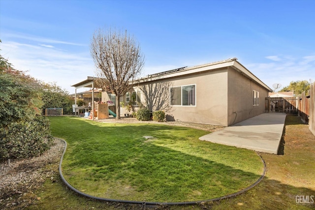 rear view of property featuring a patio and a lawn