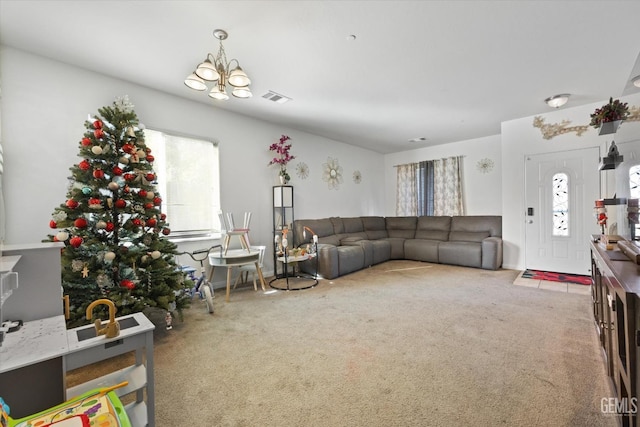 living room with an inviting chandelier and carpet