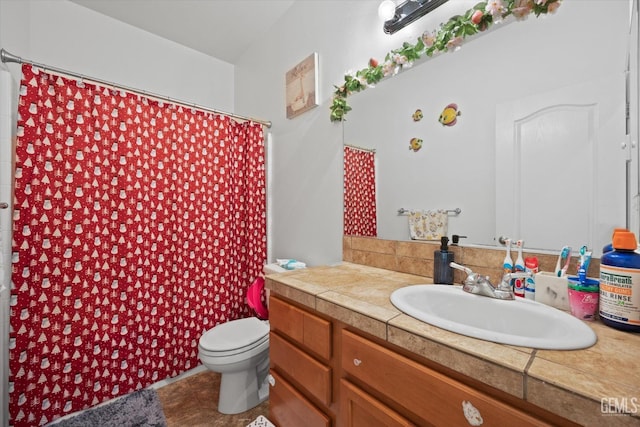 bathroom featuring walk in shower, vanity, and toilet