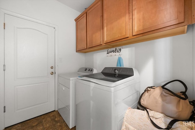 washroom with separate washer and dryer and cabinets