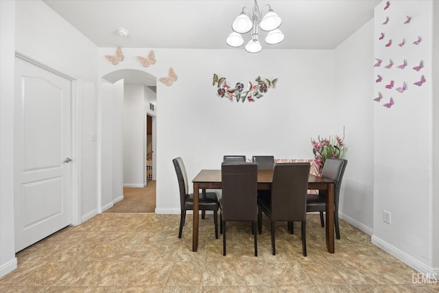 dining space with an inviting chandelier