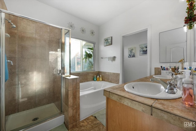 bathroom featuring independent shower and bath, vanity, and tile patterned floors