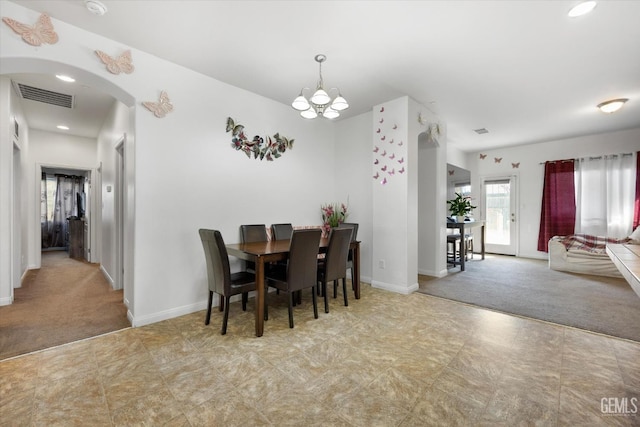 dining space featuring french doors, a notable chandelier, and light carpet