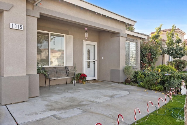 doorway to property with a patio area