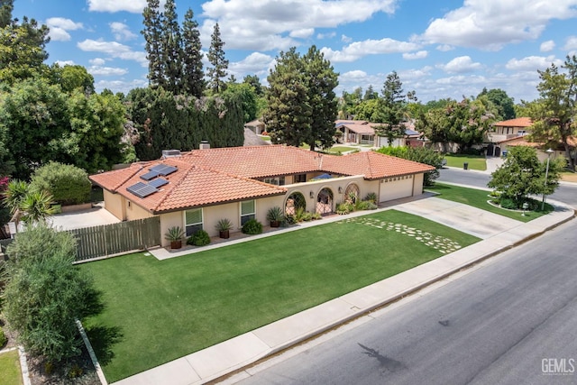 401 Via Carisma, Bakersfield, CA 93309 - mediterranean / spanish-style house with driveway, stucco siding, an attached garage, a tile roof, and solar panels