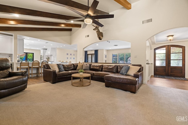 401 Via Carisma, Bakersfield, CA 93309 - living area featuring arched walkways, beam ceiling, wood finished floors, a ceiling fan, and french doors